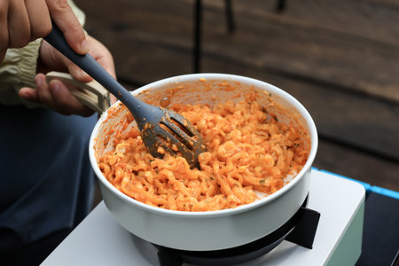 Close Up Cooking Korean Spicy Ramyeon Carbonara on Camping Ground, Outdoor Activityの写真素材