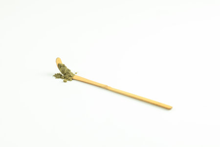 A Spoon of Matcha Powder on Greentea Matcha Scoop or Chasaku Isolated on White Background, Copy Spaceの写真素材