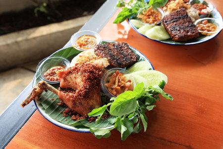 Ayam Goreng Rempah, Deep Fried Chicken with Seasoned and Flavorful Spices.  Served with Rice and Lalapanの写真素材