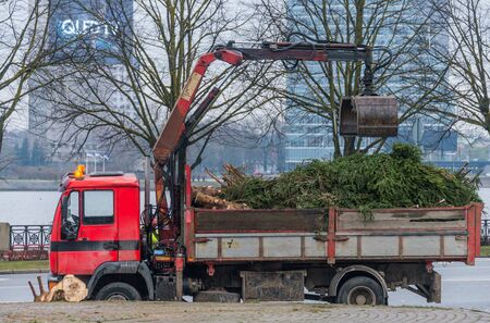 Dismantling of Christmas tree in Riga city, January 2020, truck with an excavator bucket workingの写真素材