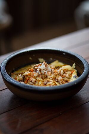 Creamy omelet with seafood on rice