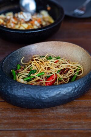 Spaghetti bacon spicy in the black bowlの写真素材
