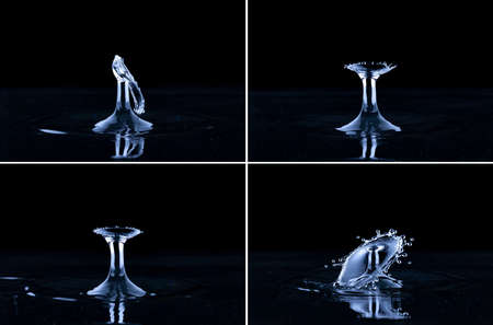 Splash and umbrella on black background. Reflection on the surface of the water.の写真素材