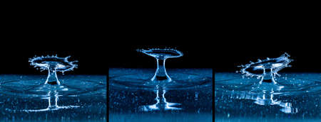 Splash and umbrella on black background. Reflection on the surface of the water.の写真素材