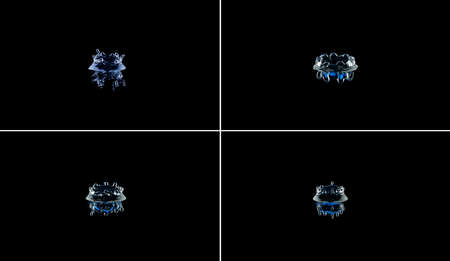 Splash and crown on black background. Reflection on the surface of the water.の写真素材