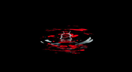 Splash and crown on black background. Reflection on the surface of the water.の写真素材