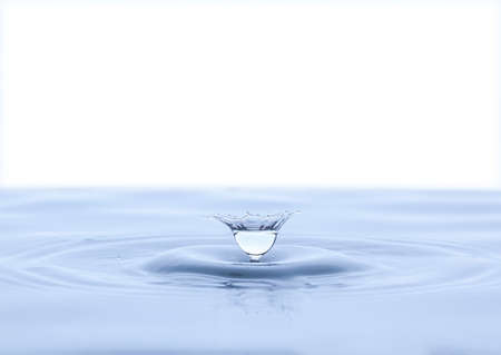 Splash and umbrella on white background. Reflection on the surface of the water.の写真素材