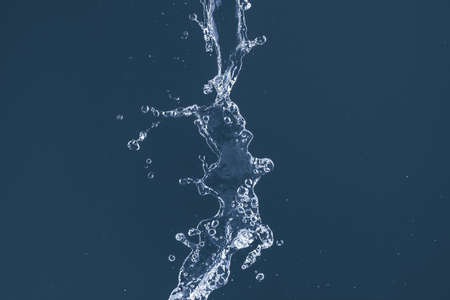 Water splash on a blue background. Reflection on the surface of the water.の写真素材