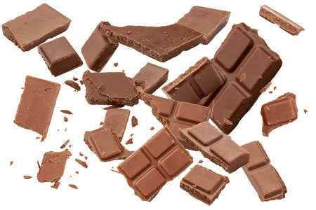 Milk chocolate broken into pieces. Chocolate bar, crumb, shavings. Chocolate slices isolated on white background.の写真素材