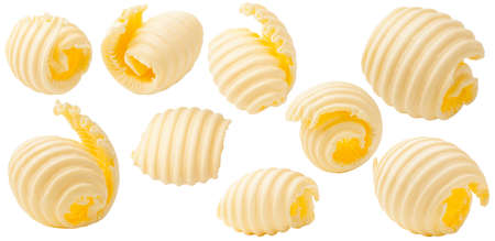 Butter curls rolled up isolated on white background. Set of pieces of butter.の写真素材