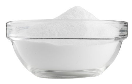 Soda in a glass bowl. Soda, flour, salt or sugar in a glass container, isolated on white background.の写真素材