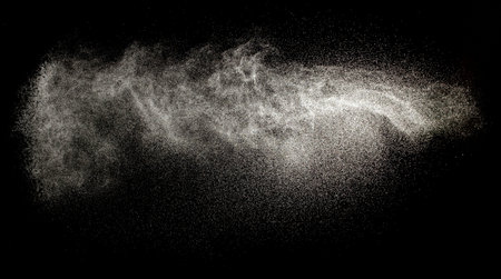 Sprayed water. Splashes and drops of water isolated on black background.の写真素材