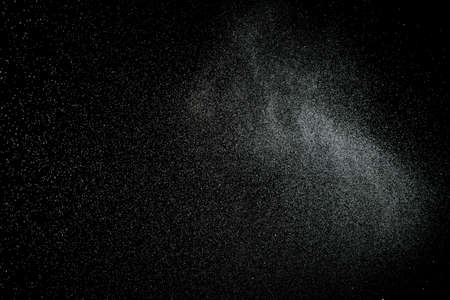 Sprayed water. Splashes and drops of water isolated on black background.の写真素材