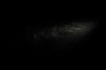 Sprayed water. Splashes and drops of water isolated on black background.の写真素材