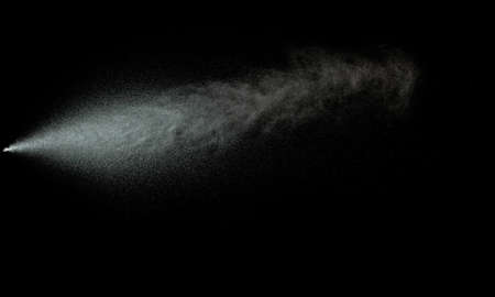 Sprayed water. Splashes and drops of water isolated on black background.の写真素材
