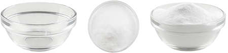 Soda in a glass bowl. Soda, flour, salt or sugar in a glass container. Two angles of a plate with white powder and an empty plate on a white background.の写真素材