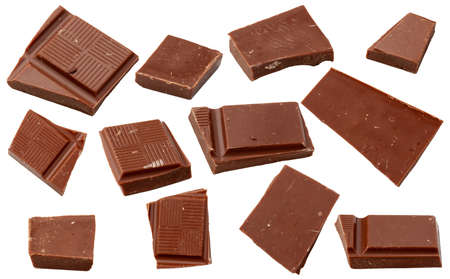 Milk chocolate. Flying pieces of milk chocolate, isolated on white background.の写真素材