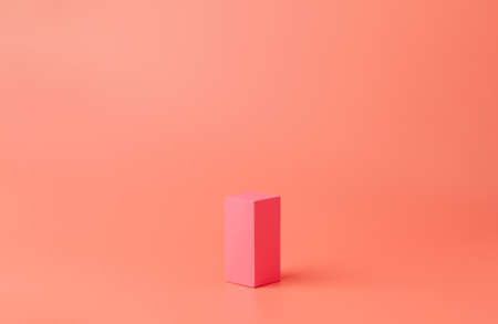 A small pink rectangle made of paper or cardboard. Geometric figure on a coral background.の写真素材