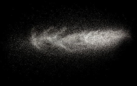 Sprayed water. Splashes and drops of water isolated on black background.の写真素材