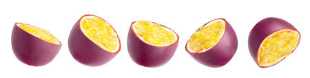 Passion fruit. Pieces of flying fruit. Purple fruits with yellow seeds flying in the air isolated on white background.の写真素材