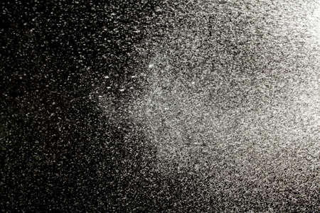 Sprayed water. Small droplets of water in the air. Lots of water drops, isolated on black background.の写真素材