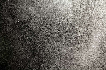 Sprayed water. Small droplets of water in the air. Lots of water drops, isolated on black background.の写真素材