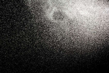 Sprayed water. Small droplets of water in the air. Lots of water drops, isolated on black background.の写真素材