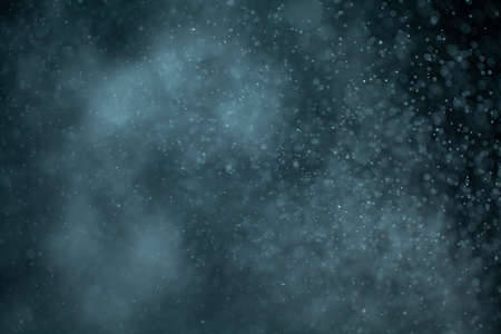 Glowing blue highlights. Wallpaper pattern. Blue sparkling spots. Dust or fog on a black background.の写真素材