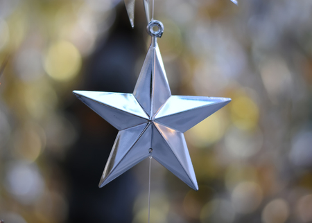 Silver Star Christmas over bokeh blurred background.の写真素材