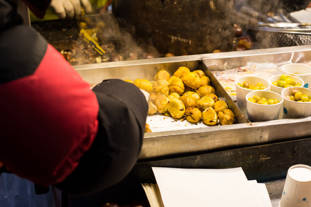 chestnuts grilling on the smoldering fireの写真素材