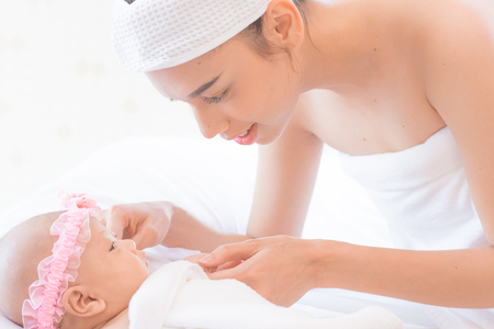 Mom and baby look at love.の写真素材