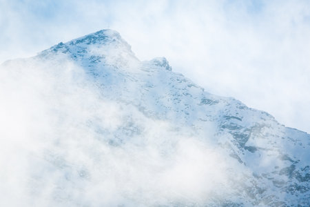 Majestic Mountain Emerging Through Fogの写真素材