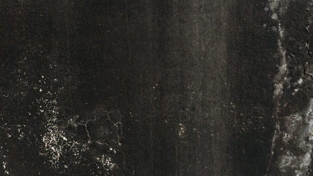 Texture of a black wall with white paintの写真素材