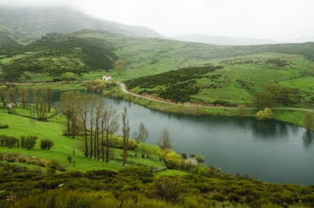 Cloudy mountain landscape crossed by a river in Gredos, Spainの写真素材