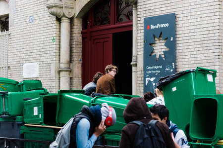 Paris, France, November 1, 2013: Group of students entering a school with containers at the door.のeditorial素材