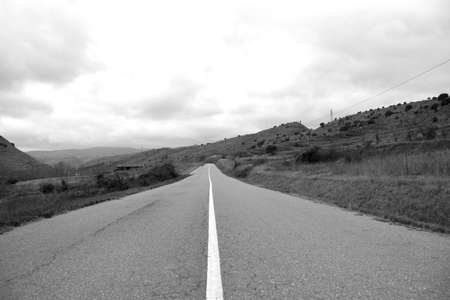 Asphalt road with continuous white line. Black and white photos.の写真素材
