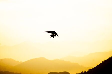 A small plane flying in the morning over the Annapurna Range Mountains of Himalayas. Tourist...