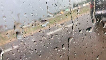 Rain splash on car window during heavy rainの写真素材