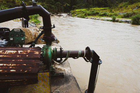 Sand dredging machine removing sand in river from river bank - Imageの写真素材