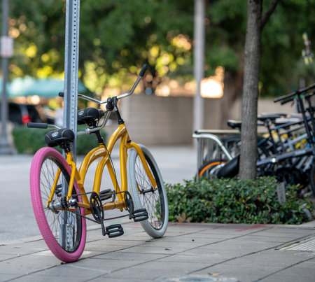 Bicycles parked in a row on the sidewalk in the cityの写真素材