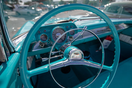 Steering wheel and dashboard of a vintage car, close-up