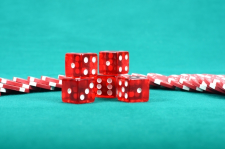 Poker gambling chips on a green playing table, stacks of poker chips , casino conceptの写真素材