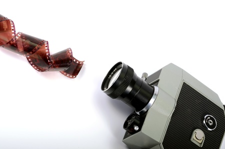 Old camera and film strip isolated