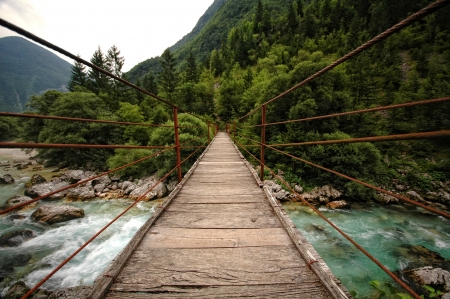 Hanging rope bridge over emerald mountain river Soca, Sloveniaの写真素材
