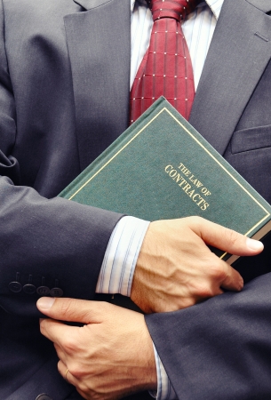 Lawyer holding criminal law book , law concept , justice conceptの写真素材
