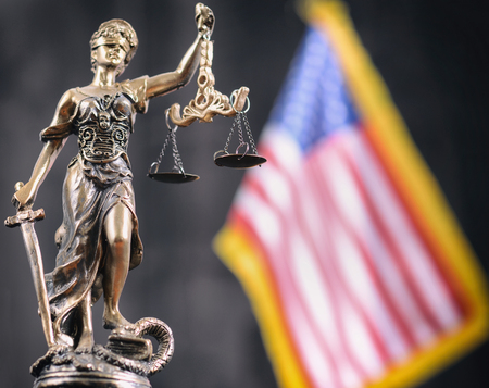 Law and Justice, Legality concept, Scales of Justice, Justitia, Lady Justice in front of the American flag in the background.の写真素材