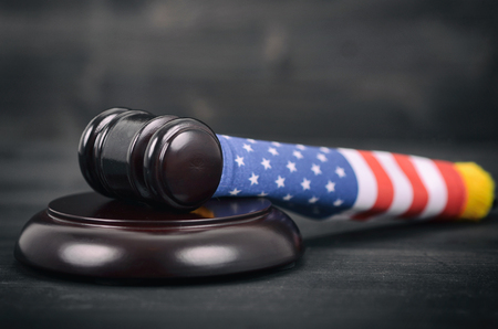 Law and Justice, Legality concept, Judge Gavel and United States of America flag on a black wooden background.の写真素材