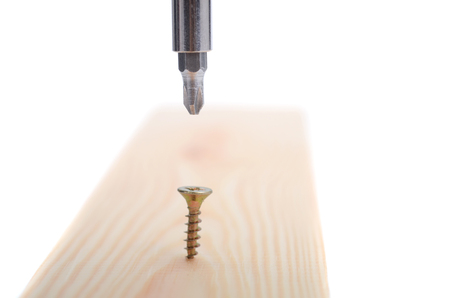 Wood Screw being screwed into a wood , Carpenter woodwork, screwing concept.の写真素材
