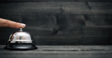 Hotel ring on black wooden  background, hotel reception service desk concept.の写真素材