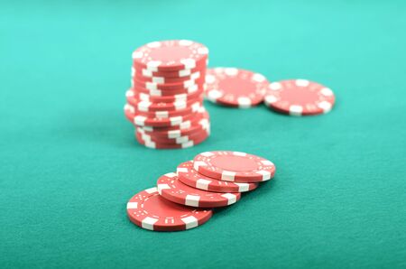 Poker gambling chips on a green playing table, stacks of poker chips , casino concept